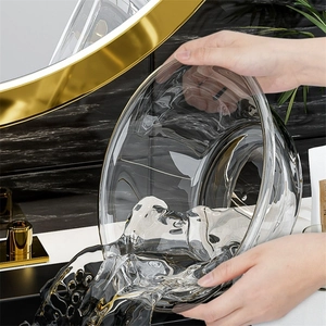 Thickened transparent PET washbasin being held in a modern minimalist bathroom setting