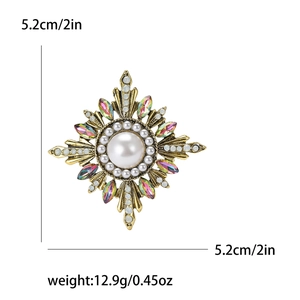 Vintage baroque sunburst brooch with large pearl and crystals on white background