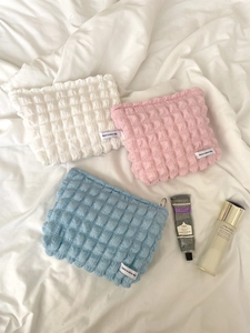 Detailed view of bubble texture storage bags in white, pink and blue colors