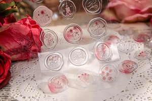 Macro shot of 3D rose-themed transparent resin stickers for scrapbooking decor