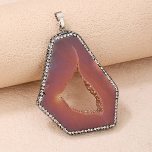Detail of natural agate geode pendant with silver plating and micro-pave crystals