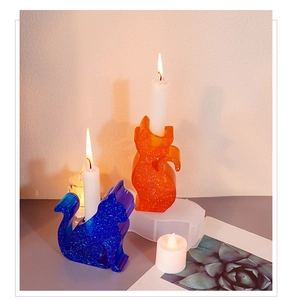 Cat shaped candle holder resin molds with blue and orange glitter finish on display