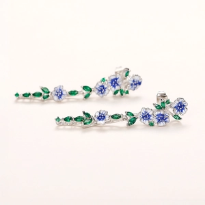 Elegant long floral earrings with blue white enamel and green crystals on silver base