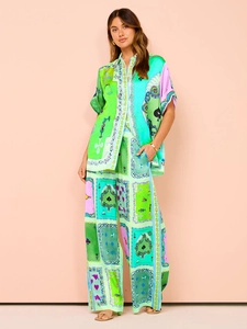 Detail of satin floral print matching set featuring short sleeve shirt and wide leg trousers