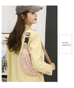 Pink PU leather fanny pack with three gold metal zippers and adjustable black strap