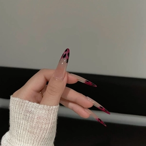 Pink and black stiletto press-on nails with cat-eye glitter and graffiti leopard patterns