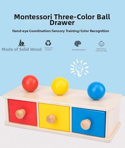 Detailed view of Montessori wooden drawer box with red, yellow, and blue balls