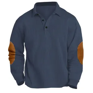 Detail of navy long sleeve polo shirt with ribbed texture and brown elbow patches