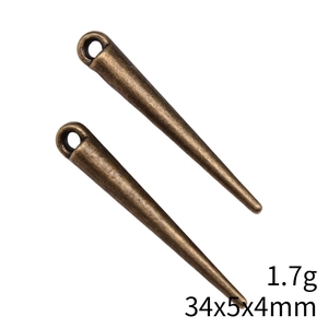 Detail view of two bronze cone spike beads with 1.7g weight and 34x5x4mm dimensions
