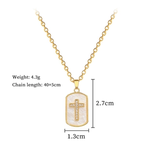 Detailed view of titanium cross pendant with shell inlay and measurement specs