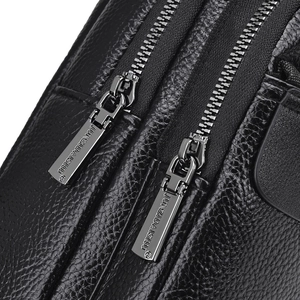Front view of black leather chest bag with two premium metal zippers and logo detailing