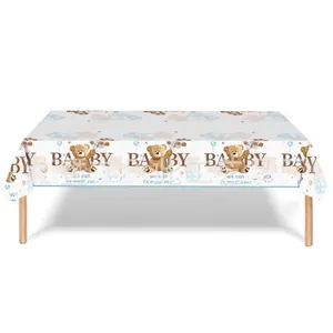 Detail of baby shower tablecloth featuring cute teddy bear and blue balloon pattern