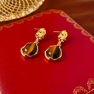 Vintage gold-plated teardrop earrings with tiger eye stone and textured metal