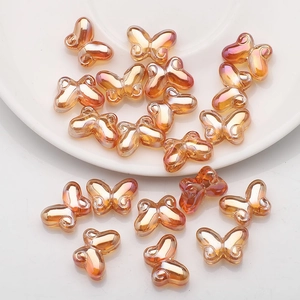 Macro detail of 10x14mm gradient orange butterfly glass beads for DIY jewelry making