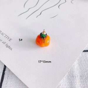 Macro view of a 17x13mm orange glass pumpkin pendant for DIY jewelry making