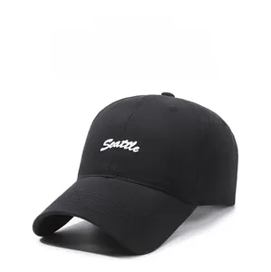 Close-up of black cotton baseball cap featuring white Seattle cursive embroidery details