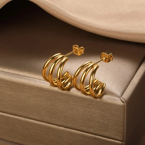 Close-up of triple-layered gold-plated stainless steel hoop earrings on a jewelry box
