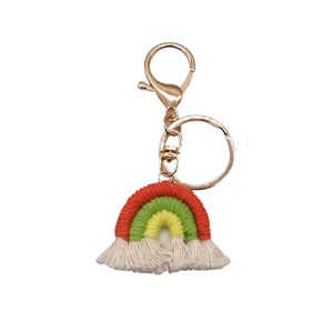 Handmade woven rainbow keychain with colorful cotton thread and white fringe on white background