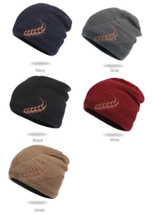 Detail showing assorted knit beanies in navy, gray, black, wine and khaki with wheat embroidery