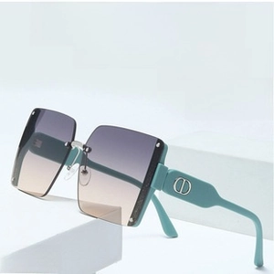 Side view of square sunglasses with gradient lenses and mint green CD logo temples
