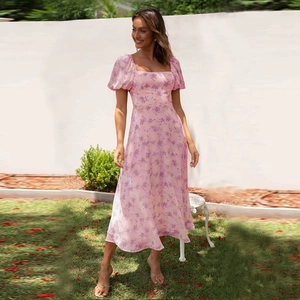 Detailed view of the puff sleeves and floral chiffon fabric on a pink summer dress