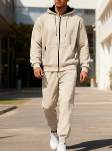 Outdoor shot of men's beige fleece tracksuit featuring zip-up hoodie and matching joggers