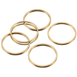 Detail view of five polished golden stainless steel round rings for DIY jewelry accessories