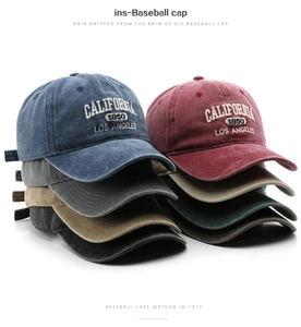 Stack of vintage washed cotton baseball caps showing diverse colors and embroidery detail