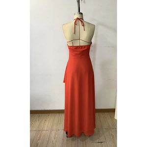 Detail of red halter maxi dress showing backless design and chiffon fabric texture