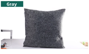 Detailed close-up of dark gray felt pillow cover with fiber texture and hidden zipper