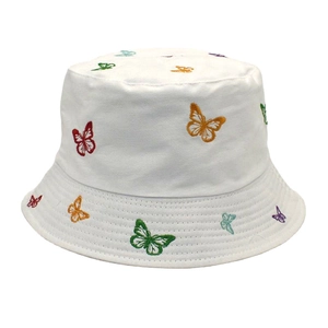 Close-up of multicolor butterfly embroidery on a white cotton reversible bucket hat