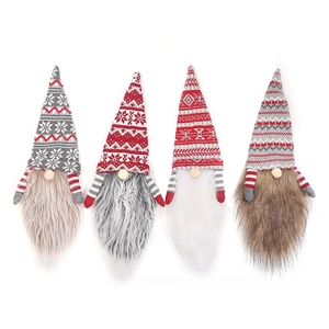 Close-up of four knitted Christmas gnome wine bottle covers in red, grey, and brown patterns