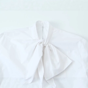 Elegant white women's blouse with bow-tie neck and premium cotton texture