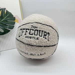 Close-up of cream teddy fleece basketball pillow with black Offcourt embroidery detail