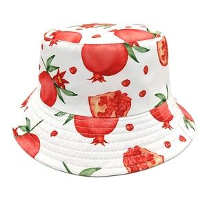 Detail of red pomegranate print on a white bucket hat with hand-painted watercolor style