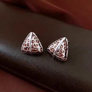Luxury 14K gold plated triangular leopard print stud earrings on brown leather