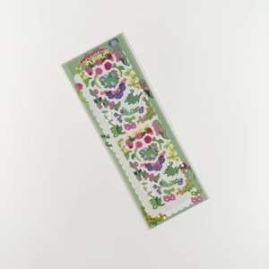 Close-up of holographic garden flower stickers with glitter finish for scrapbooking