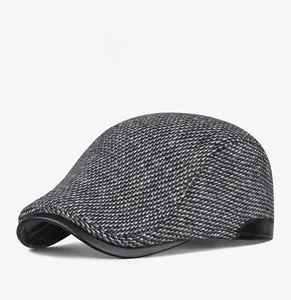 Detail view of winter plaid ivy cap showing textured fabric and leather edge trim