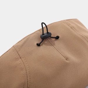 Close-up of khaki twill cotton cap showing adjustable toggle and metal eyelet detail