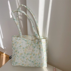 Detailed close-up of quilted floral cotton tote bag featuring light green flower patterns