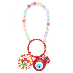 DIY keychain with red ring, colorful bead chain and evil eye charm on white background