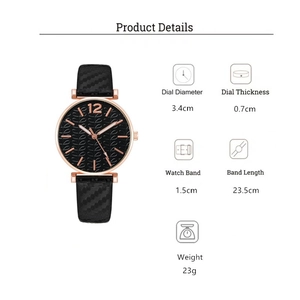 Detail view of quartz watch with black textured strap and rose gold leaf pattern dial