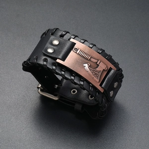 Close-up of black braided leather bracelet with bronze Viking axe charm and buckle strap