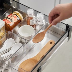 Transparent plastic drawer organizer for kitchen cutlery and utensils in a tidy storage tray