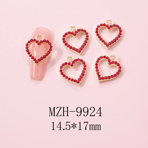 Detail of 14.5x17mm heart nail charms with red rhinestones and hollow gold alloy base