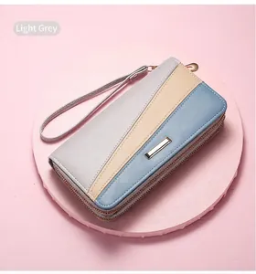 Detail of multi-functional tri-color leather wallet with dual zippers and wrist strap
