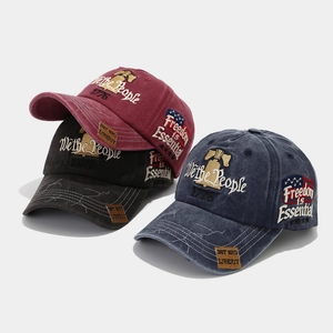 Detailed embroidery of We the People and Freedom is Essential on distressed baseball caps