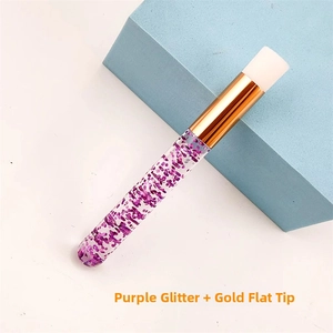 Detail view of purple sequin lash cleaning brush with gold ferrule and flat silicone head