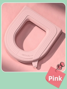 Detail of pink waterproof EVA toilet seat cover with BROUD logo and soft texture