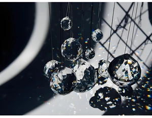 Macro shot of faceted K9 crystal ball prisms hanging to refract rainbow light